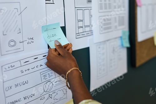 Preview: Young Adult Black Woman Adjusting Sticky Note during Ux Design Planning Session