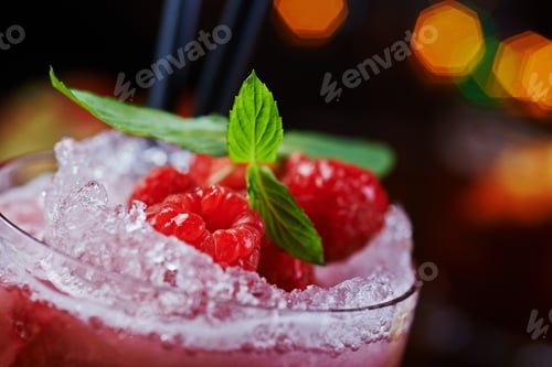 Preview: bright glass of alcoholic cocktail or lemonade on a table in a bar. soft focus.