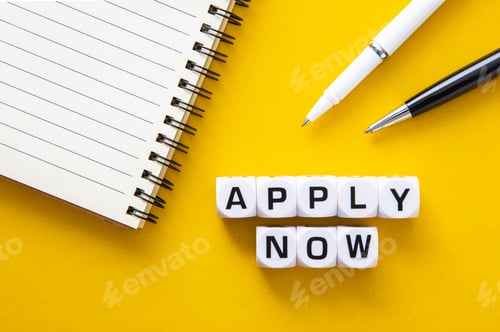 Preview: Business concept. Notepad and pen with the text APPLY NOW