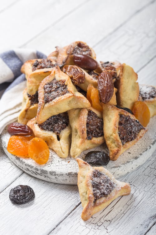 Preview: Traditional Jewish Hamantaschen cookies with dried apricots, dates. Purim celebration concept.