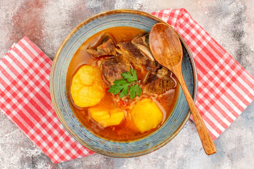 Preview: top view homemade bozbash soup kitchen towel a wooden spoon on nude background azerbaijani cuisine