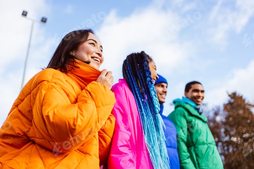 Preview: Multiracial group of young friends meeting outdoors in winter
