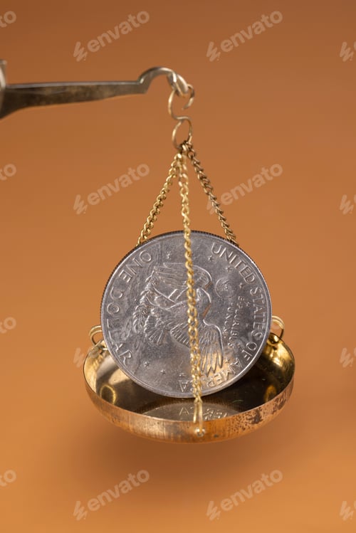 Preview: Close-up of gold coins on brass scales, importance and weight of money