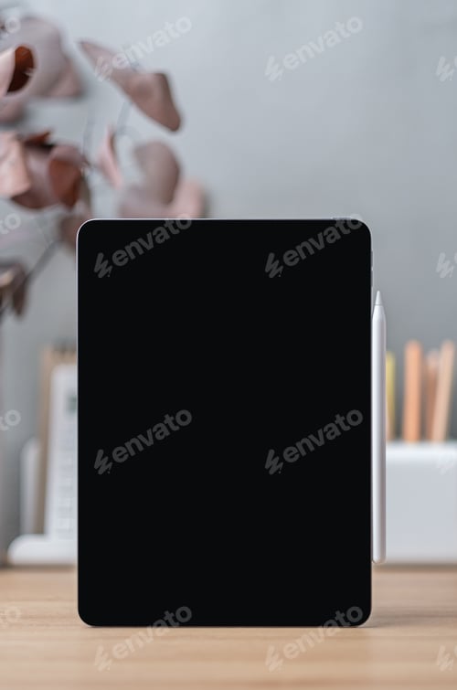Preview: Blank screen tablet on working desk decor with stationery at home