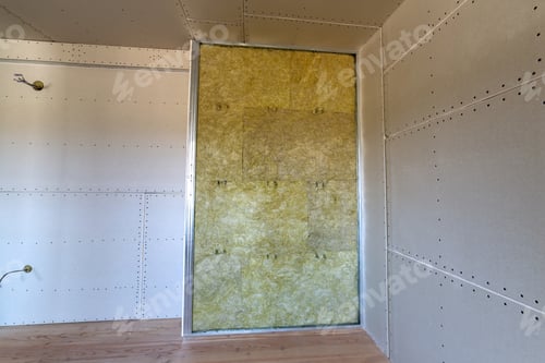 Preview: Wall of a room under renovation with mineral rock wool insulation and metal frame prepared for