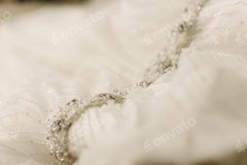 Preview: Detail of the fabric of a white wedding dress.
