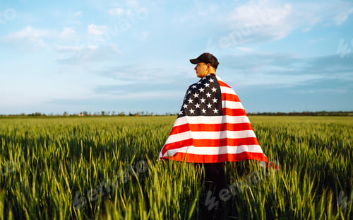 Preview: Man hold waving american USA flag. Patriot raise national american flag. Independence Day, 4th July.