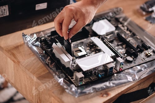 Preview: Closeup shot of a hand of the technician repairing the pc motherboard