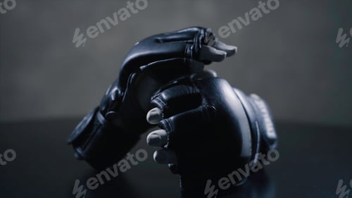 Preview: Fist black gloves for martial arts , mma. Pair of boxing gloves on a desk. Concept image, the idea