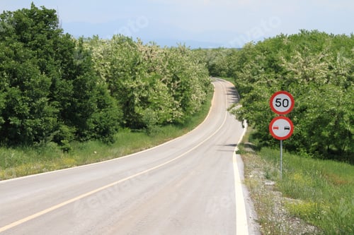 Preview: Winding country road with speed limit sign