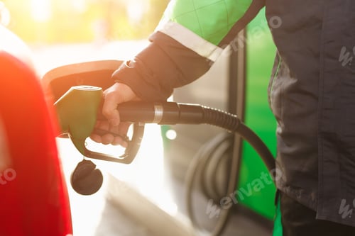 Preview: Crop employee filling car with fuel