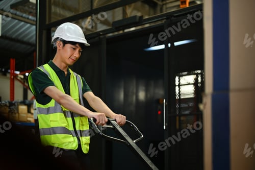Preview: Shot of male worker in safety hardhats pulling a pallet truck walking through rows.