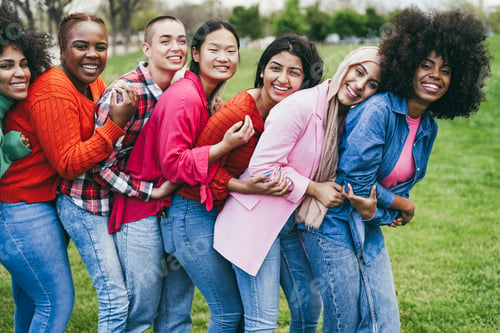 Preview: Multiracial female friends having fun hugging together outdoor - Focus on arabian girl face