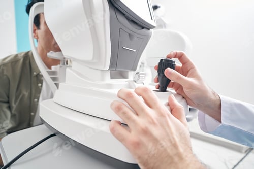 Preview: Adult doctor working at the refraction machine