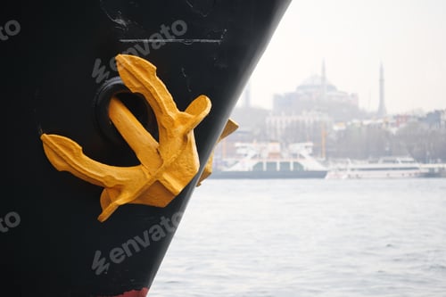 Preview: Anchor on the bow of a ship in a harbor with city backdrop