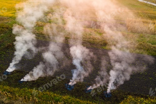 Preview: Aerial view of agricultural waste bonfires from dry grass and straw stubble burning with thick smoke