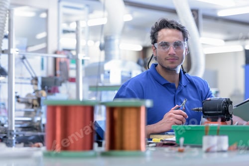 Preview: Portrait of male worker in electronics factory