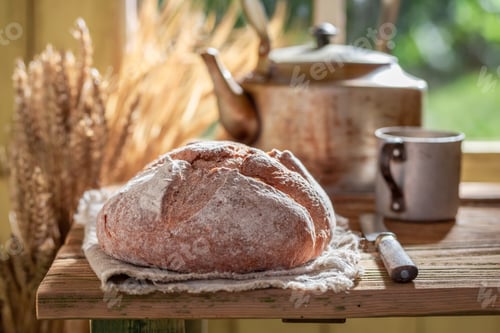 Preview: Rustic and fresh loaf of bread in morning in countryside.
