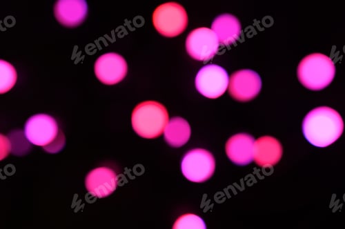 Preview: blurred night pink glowing lights on black background. new year and christmas concept