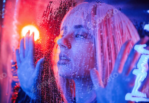 Preview: Focused close up view. Stylish woman with white hair is behind wet transparent plastic sheet