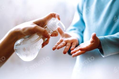 Preview: Hands with sanitizer gel. Mother and child using sanitize soap for hand coronavirus protection.