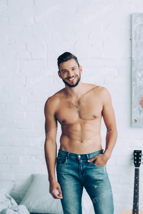 Preview: smiling shirtless man with muscular torso posing in bedroom at home