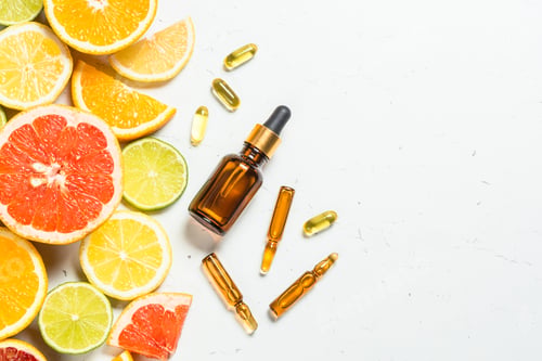 Preview: Vitamin C. Cosmetic products and fresh citrus fruits