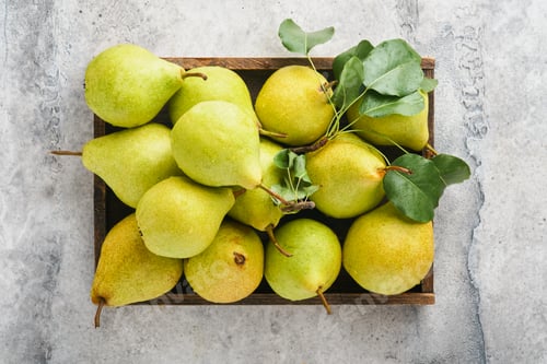 Preview: Pears. Fresh sweet organic pears with leaves in wooden box or basket on old gray stone tile backgrou