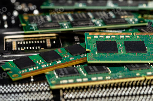 Preview: A stack of old SDRAM memory modules lying on a printed circuit board.