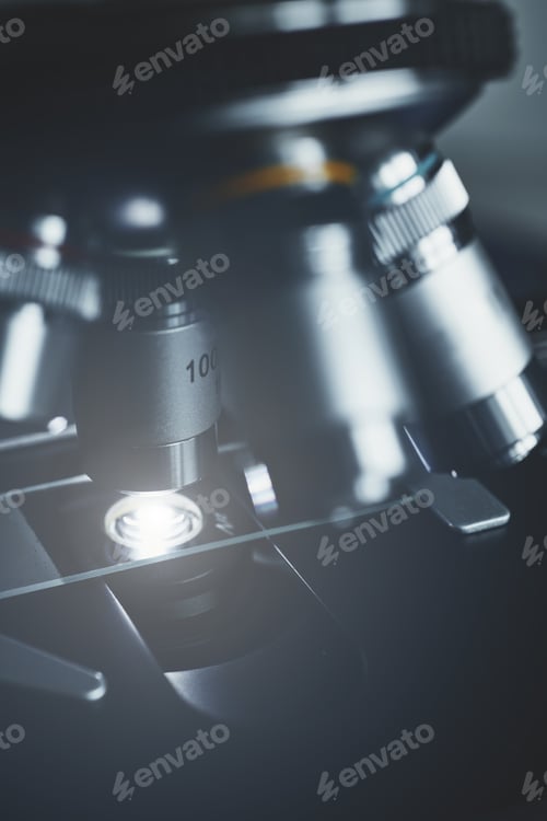 Preview: Modern microscope with metal lens at laboratory.