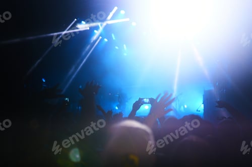Preview: Hand with a phone records live music festival. People taking photographs with phone during concert.