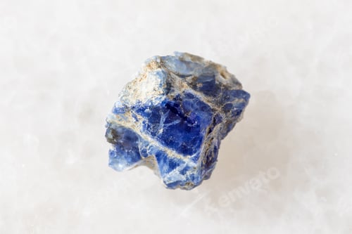 Preview: sample of raw benitoite crystal on white marble