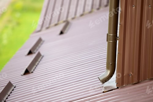 Preview: Close-up of brown new gutter metal system pipe on wall. Drain protection, professional work concept.