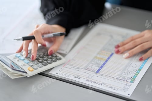 Preview: Asian woman preparing tax return documents