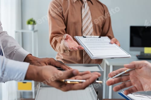 Preview: Real estate agent giving contract to client during meeting