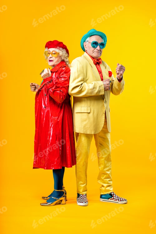 Preview: Beautiful senior old couple wearing fancy party clothes acting in studio on a colored background.