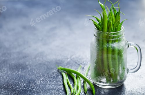 Preview: Green Beans in Glass Jar on Grey Stone Background. Copy Space.