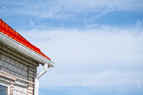 Preview: Rain Gutter Pipeline System on brick house , bright red metal tile roof