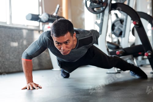 Preview: Sportsman doing one arm push-ups