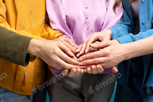 Preview: Businesswomen joining hands showing teamwork and cooperation