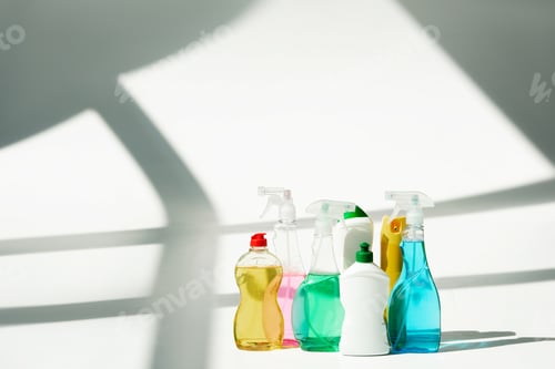 Preview: various bottles and sprayers with cleaning products on white