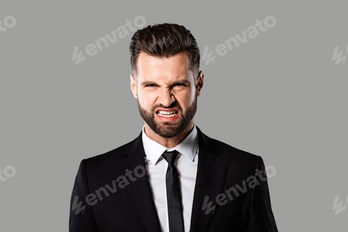 Preview: angry bearded businessman in black suit isolated on grey