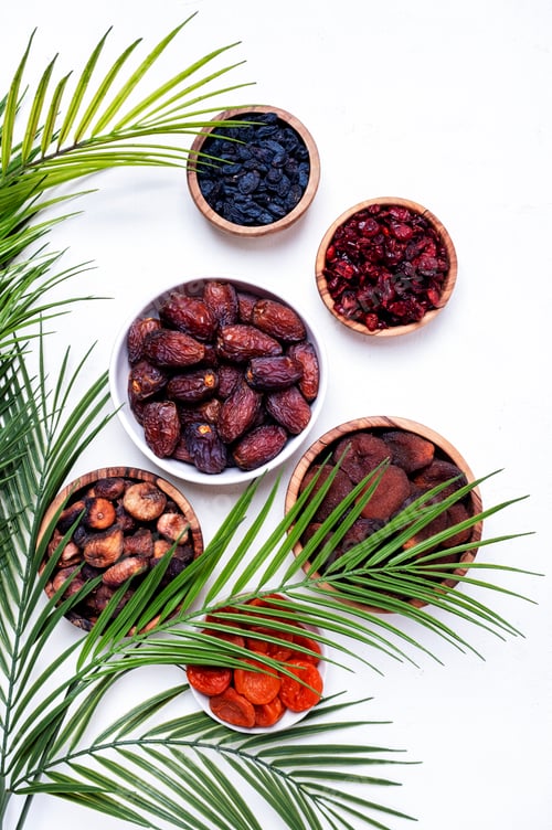 Preview: Organic sun dried fruits in bowls on white background. Healthy wholesome snacks