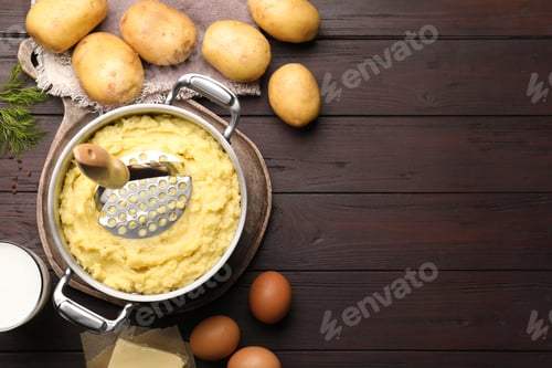 Preview: Flat lay composition with tasty mashed potatoes and ingredients on wooden table. Space for text
