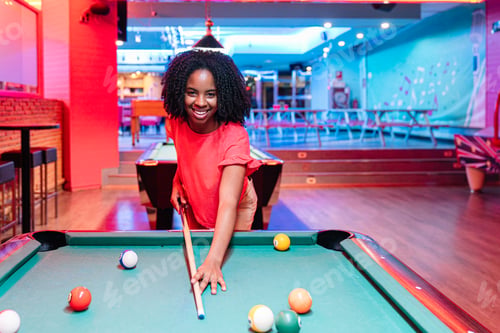 Preview: Young woman playing billiards in a colorful entertainment venue