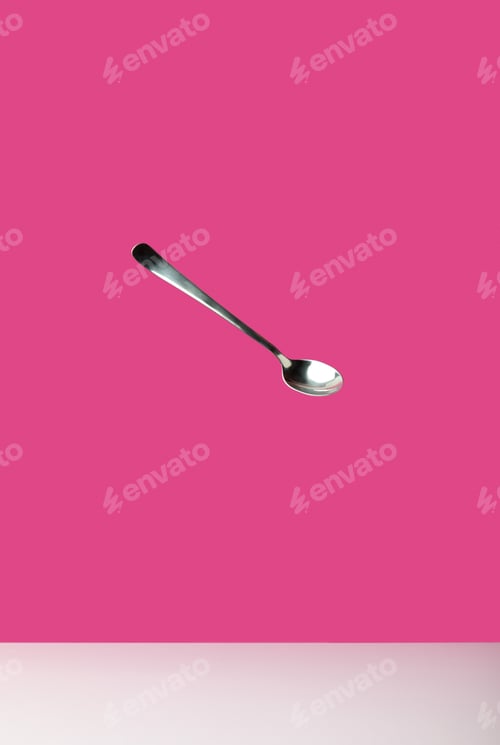 Preview: close-up view of single empty spoon isolated on pink