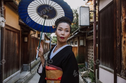 Preview: Beautiful japanese senior woman walking in the village. Typical japanese traditional lifestyle