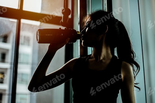 Preview: The sports young woman drinks protein in a shaker in a gym. Sports