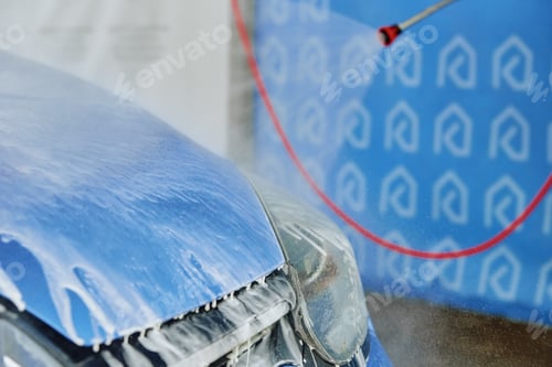 Preview: Cleaning car with high pressure water at car wash station