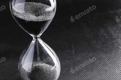 Preview: Hourglass on dark background. Macro photo. Close up